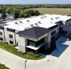 Aerial view of a white commercial roof with rooftop equipment