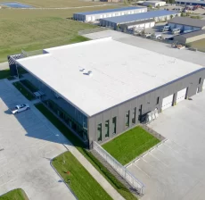 Aerial view of a commercial building with a white low-slope roof