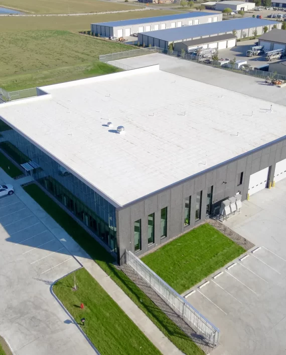 Aerial view of a commercial building with a white low-slope roof