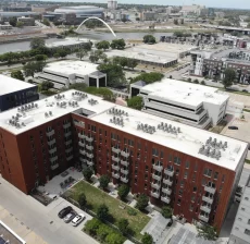 Aerial view of commercial rooftops and surrounding city buildings
