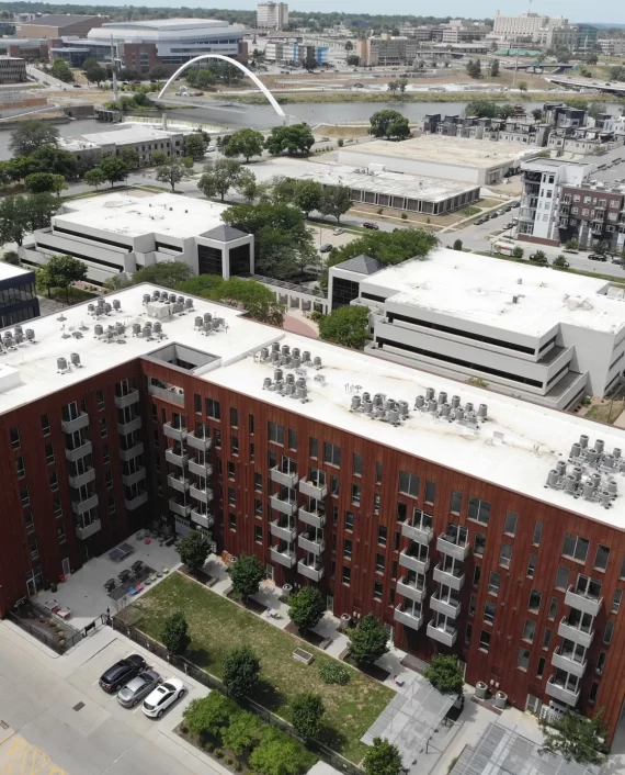 Aerial view of commercial rooftops and surrounding city buildings